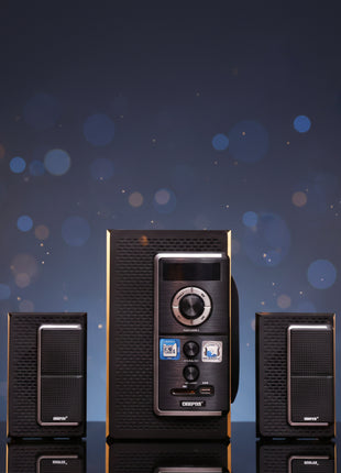 Black stereo system with two speakers on a wooden surface