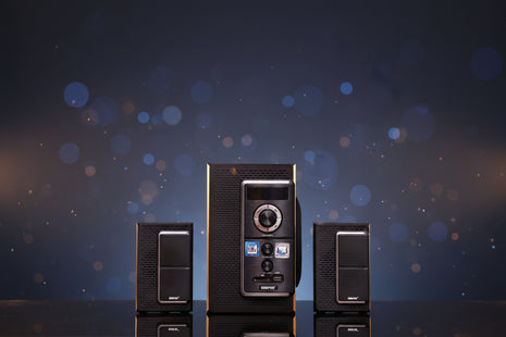 Black stereo system with two speakers on a wooden surface